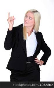 Businesswoman pointing her finger upwards