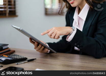 Businesswoman pointing on tablet to reading finance data and marketing plan of new startup project.