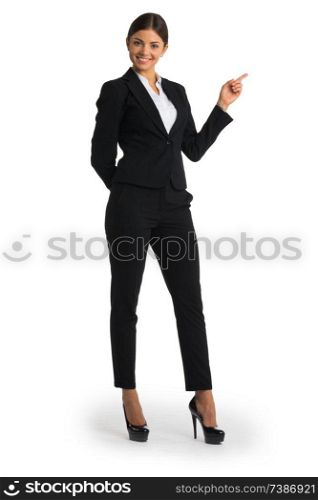 Businesswoman pointing with finger at empty copy space, studio isolated on white background, full length portrait. Businesswoman pointing with finger