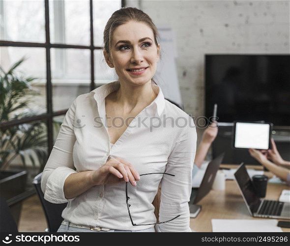 businesswoman posing during meeting indoors