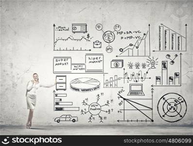 Businesswoman present her ideas. Beautiful businesswoman leaning on banner with plan sketches