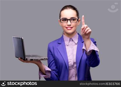 Businesswoman pressing button holding laptop