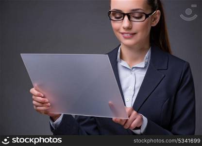 Businesswoman pressing buttons on tablet