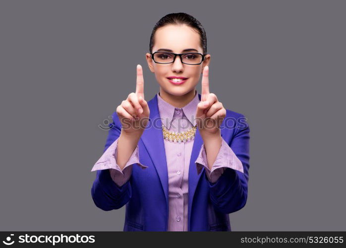 Businesswoman pressing virtual button on gray background