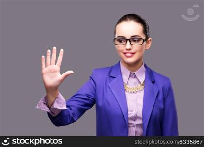 Businesswoman pressing virtual button on gray background