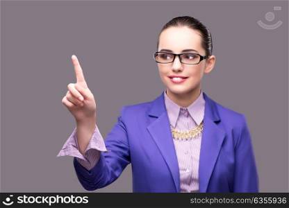 Businesswoman pressing virtual button on gray background