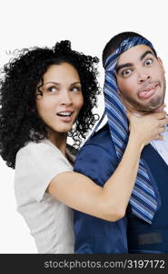 Businesswoman pretending to strangulate a businessman