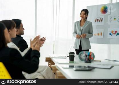Businesswoman proficiently present work project receive celebrations from team . Corporate business team collaboration concept .. Businesswoman proficiently present work project receive celebrations from team