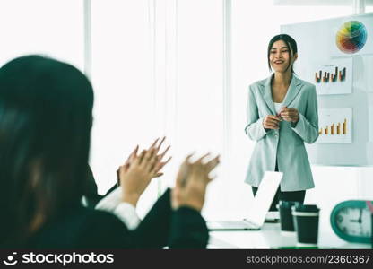 Businesswoman proficiently present work project receive celebrations from team . Corporate business team collaboration concept .. Businesswoman proficiently present work project receive celebrations from team