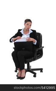 Businesswoman pulling a document out of her briefcase