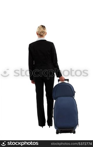 Businesswoman pulling a suitcase