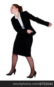 Businesswoman pulling an invisible chain