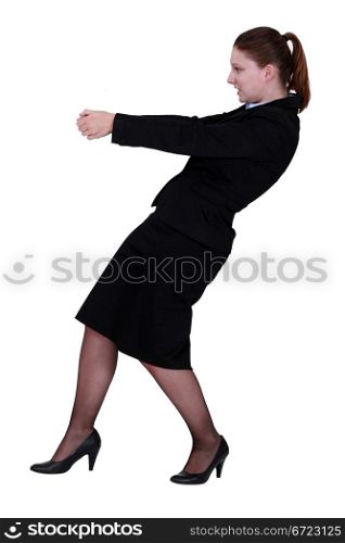 Businesswoman pulling an invisible object