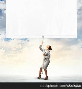 Businesswoman pulling banner. Image of businesswoman pulling blank banner. Place for text
