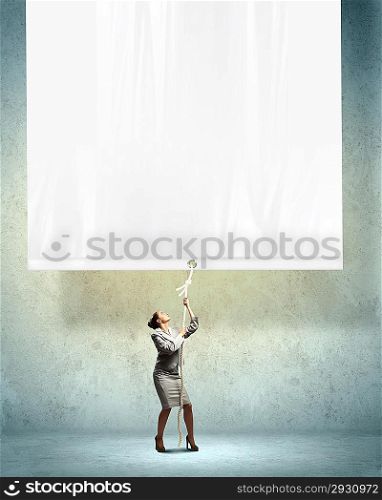 Businesswoman pulling blank banner