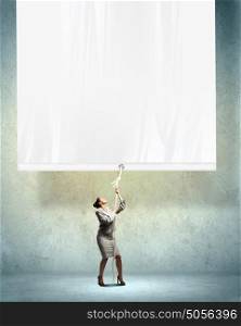 Businesswoman pulling blank banner. Image of young businesswoman pulling blank banner. Place for text