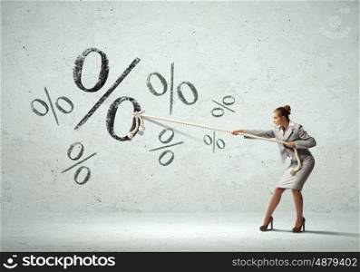 Businesswoman pulling rope. Image of attractive businesswoman pulling rope with percent sign