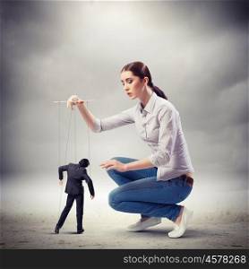 Businesswoman puppeteer. Image of pretty businesswoman puppeteer. Leadership concept