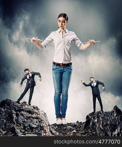 Businesswoman puppeteer. Image of pretty businesswoman puppeteer. Leadership concept