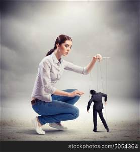 Businesswoman puppeteer. Image of pretty businesswoman puppeteer. Leadership concept