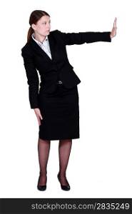 Businesswoman pushing an invisible wall