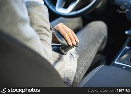businesswoman putting seat belt car