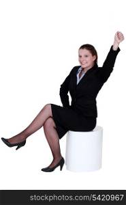 Businesswoman reaching into the air