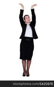 Businesswoman reaching up