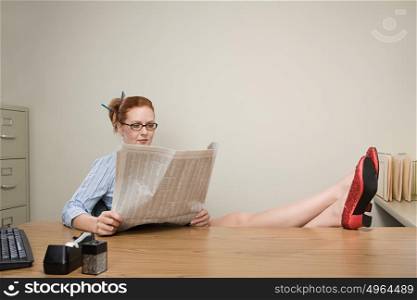 Businesswoman reading a newspaper