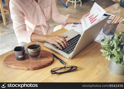 Businesswoman reading financial graph charts Planning analyzing marketing data. Women hands using smartphone, laptop on office desk. Hands of young asian woman working in office firm business info.