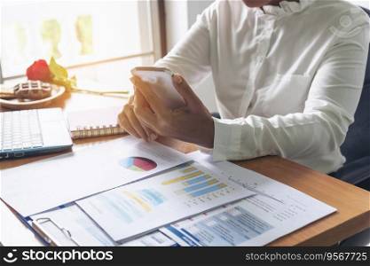 Businesswoman reading financial graph charts Planning analyzing marketing data. Women hands using smartphone, laptop on office desk. Hands of young asian woman working in office firm business info.