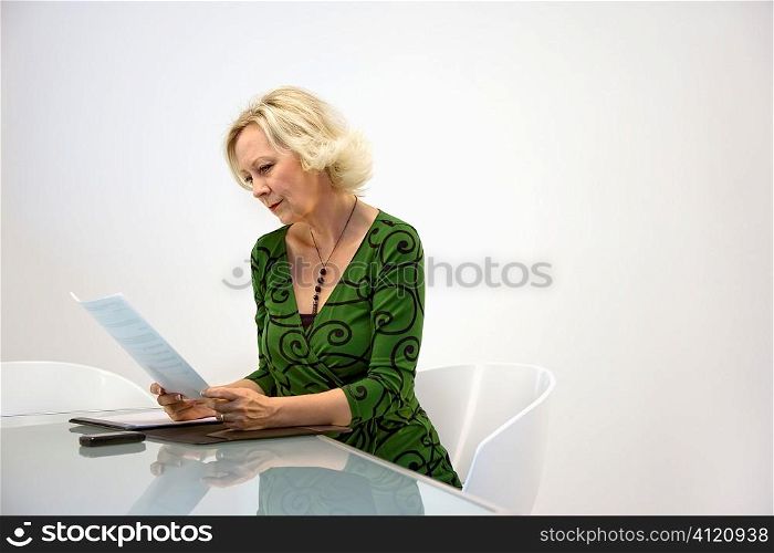 Businesswoman reading paperwork