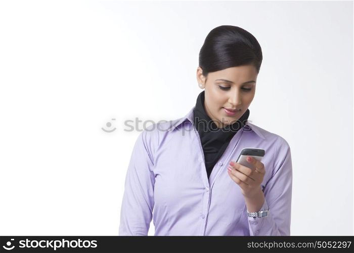 Businesswoman reading sms on mobile phone