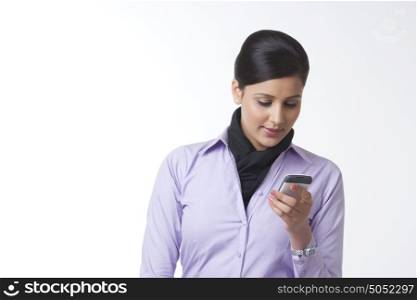 Businesswoman reading sms on mobile phone