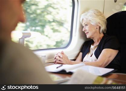 Businesswoman Relaxing On Train Journey