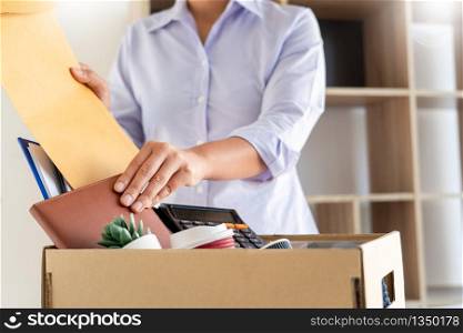 Businesswoman resigning from her job hold boxes and packing personal company for personal belongings. deciding resignation concept and changing work in future