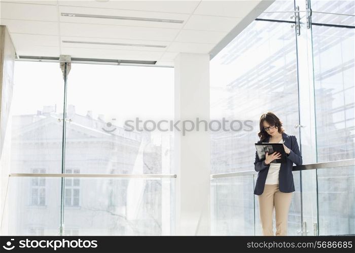 Businesswoman reviewing documents in office