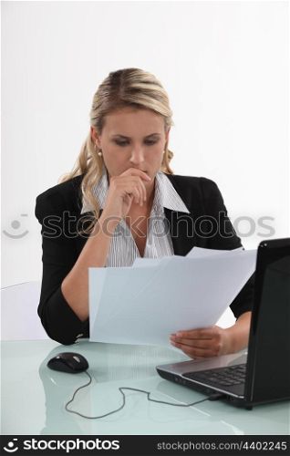 Businesswoman reviewing paperwork