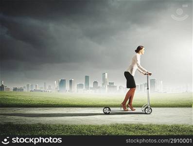 Businesswoman riding a scooter