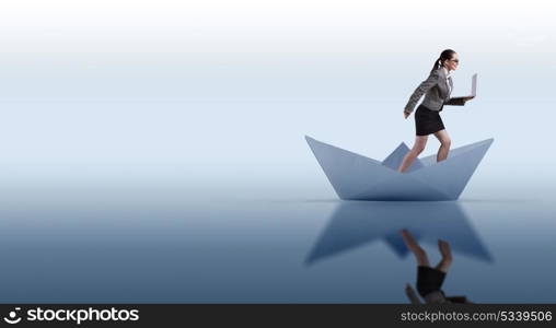 Businesswoman riding paper boat ship in business concept