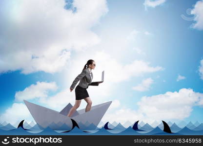 Businesswoman riding paper boat ship in business concept