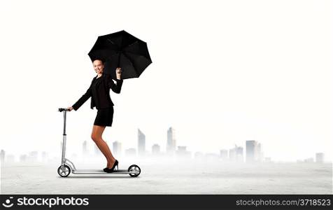 Businesswoman riding scooter