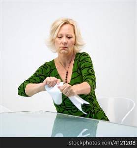 Businesswoman ripping papers