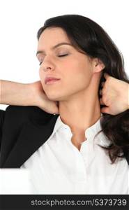 Businesswoman rubbing her neck