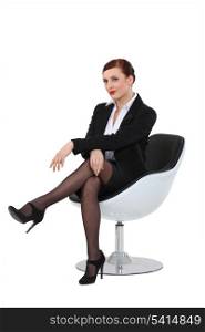 Businesswoman sat in swivel chair