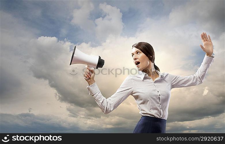 Businesswoman screaming in megaphone