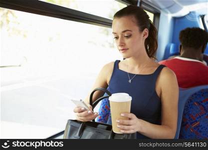 Businesswoman Sending Text Message On Bus