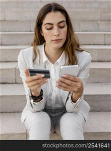 businesswoman shopping online with smartphone credit card