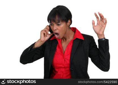 Businesswoman shouting down the phone