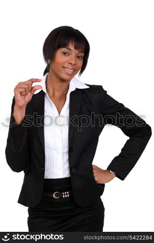 Businesswoman showing a little sign
